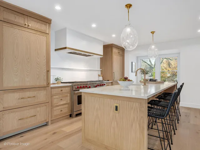 a dining room with wooden floor and furniture