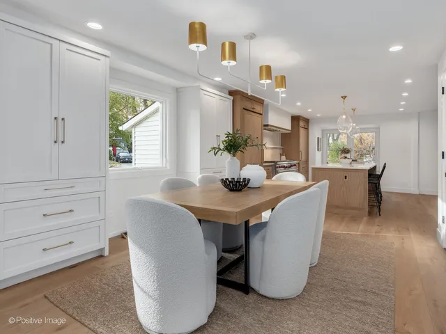 a living room with fireplace furniture and a table