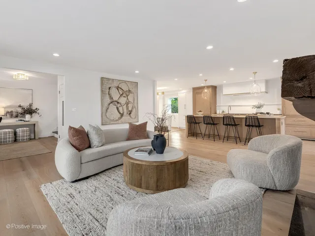 a living room with furniture and a view of kitchen