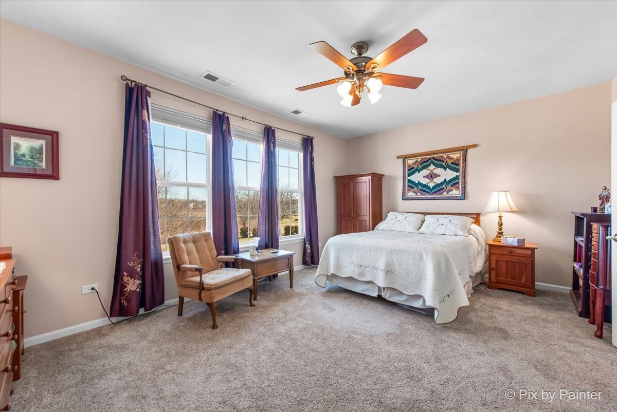 12290 Russet Lane Huntley, IL 60142 - Photo 17 of 38 a bedroom with a bed and a large window
