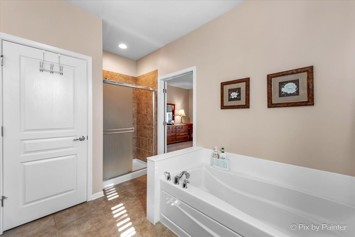 12290 Russet Lane Huntley, IL 60142 - Photo 20 of 38 a bathroom with a tub a shower and a sink