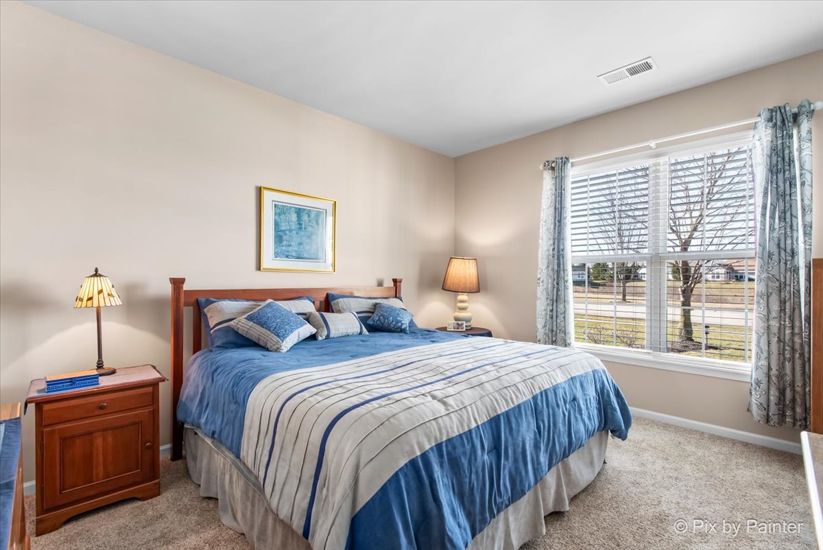 12290 Russet Lane Huntley, IL 60142 - Photo 21 of 38 a bedroom with a large bed and a window