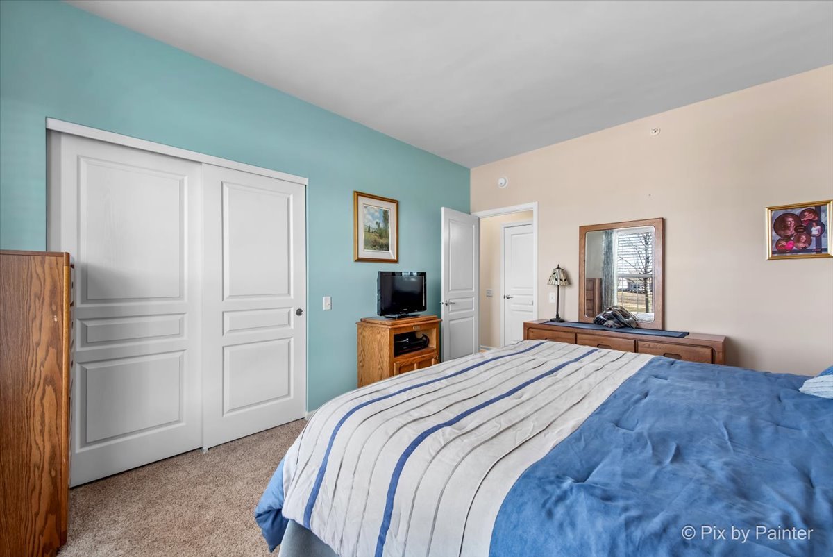 12290 Russet Lane Huntley, IL 60142 - Photo 22 of 38 a bedroom with a bed and a refrigerator