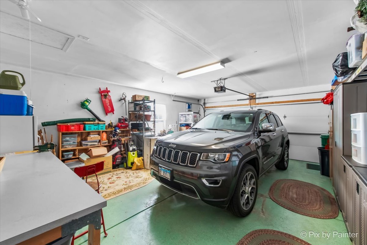 12290 Russet Lane Huntley, IL 60142 - Photo 27 of 38 a car and bike parked in a garage