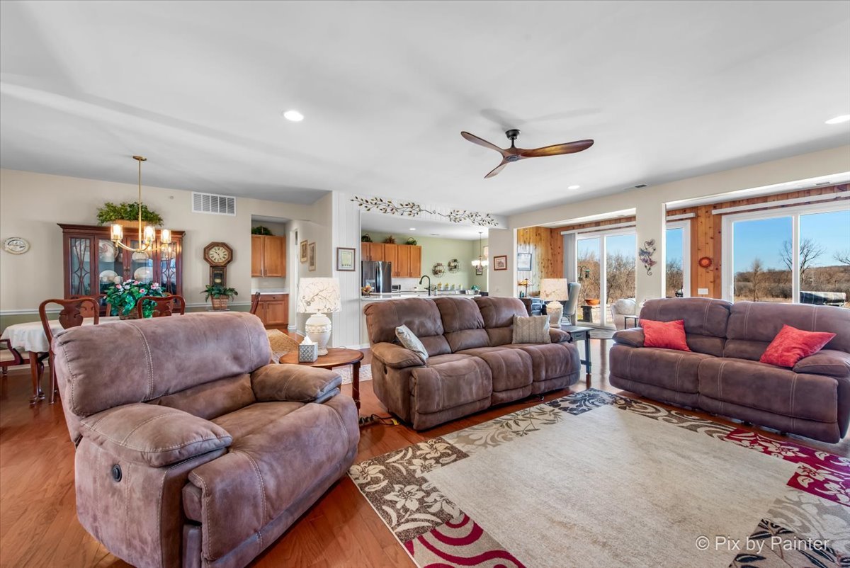 12290 Russet Lane Huntley, IL 60142 - Photo 6 of 38 a living room with furniture a ceiling fan and a rug
