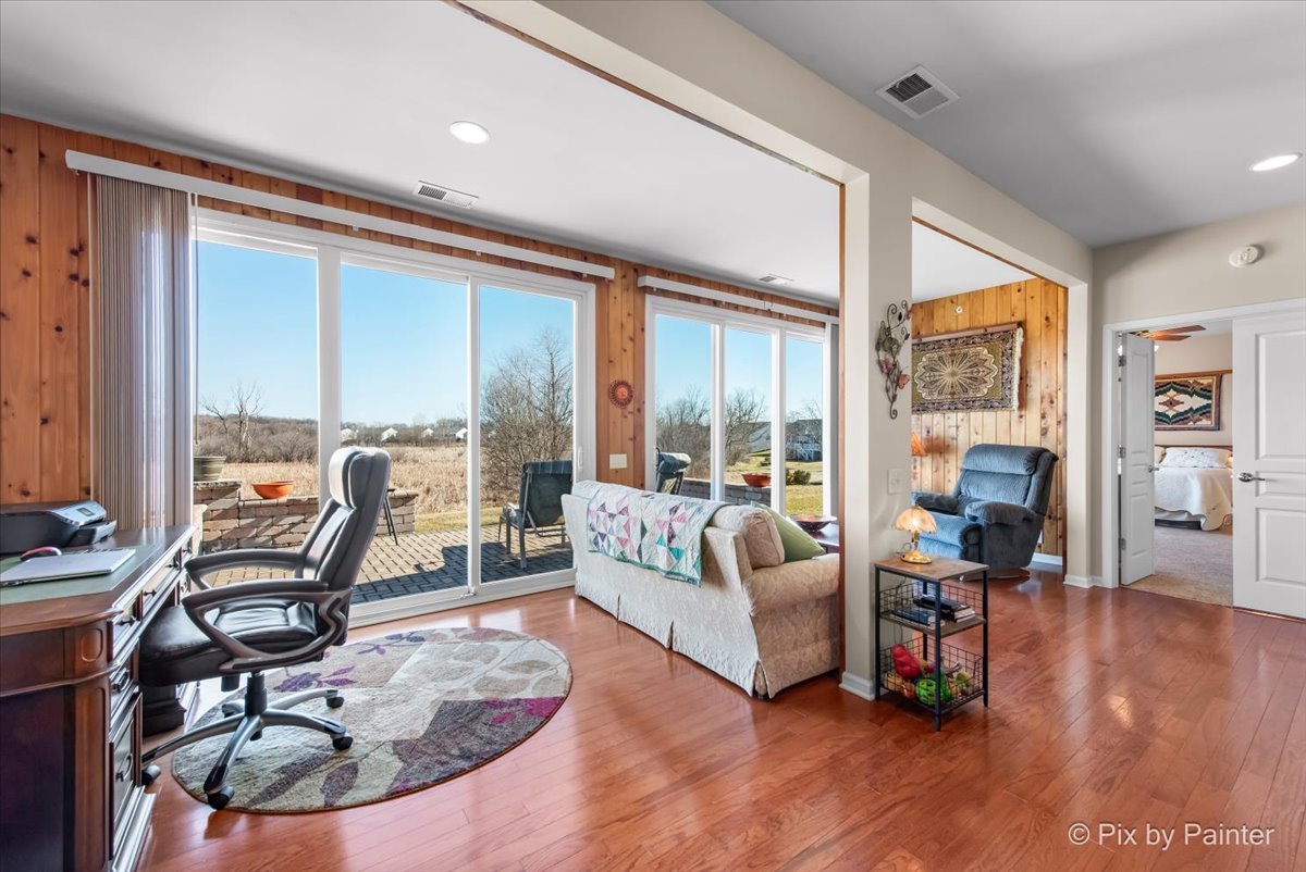 12290 Russet Lane Huntley, IL 60142 - Photo 10 of 38 a living room with furniture large windows and wooden floor