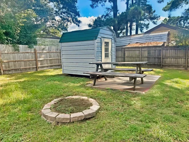 a view of backyard with a garden and deck