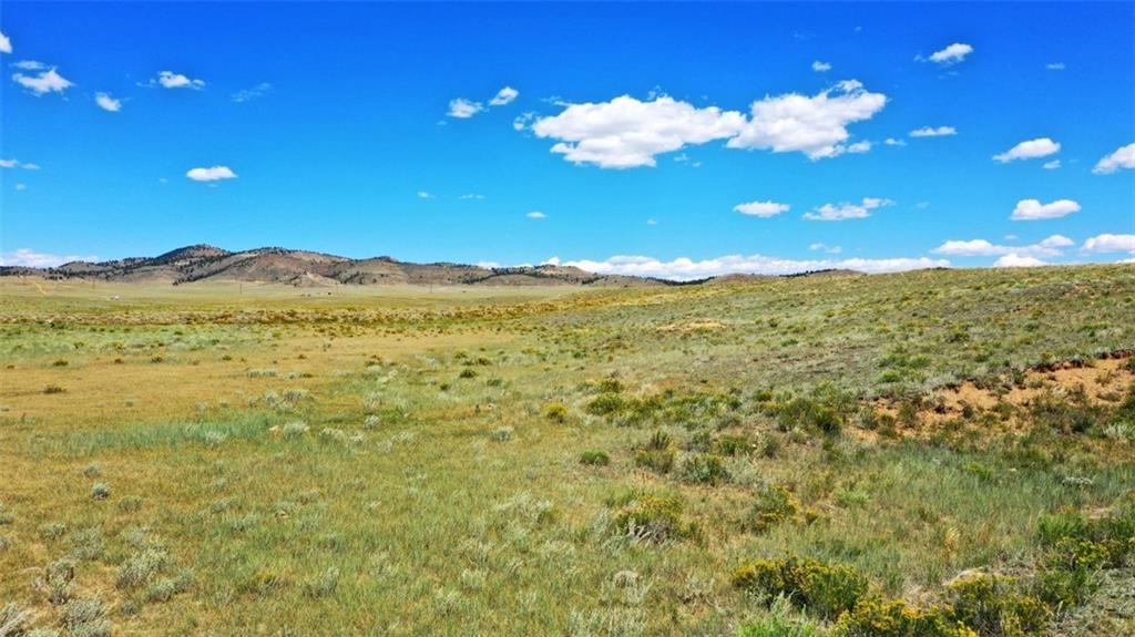 427 East Ranger Hill Road Hartsel, CO 80449 - Photo 14 of 15 a view of a building with mountains in the background