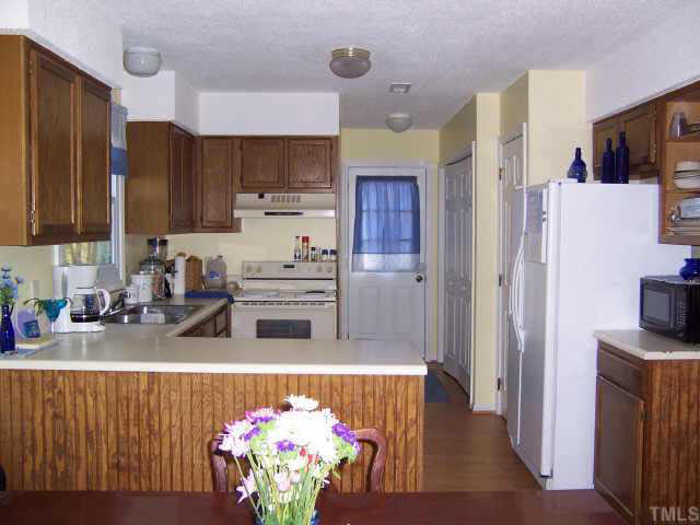 990 Templeridge Road Wake Forest, NC 27587 - Photo 4 of 7 a kitchen with stainless steel appliances a refrigerator sink and cabinets