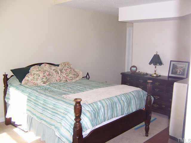 990 Templeridge Road Wake Forest, NC 27587 - Photo 7 of 7 a bedroom with a bed and wooden floor