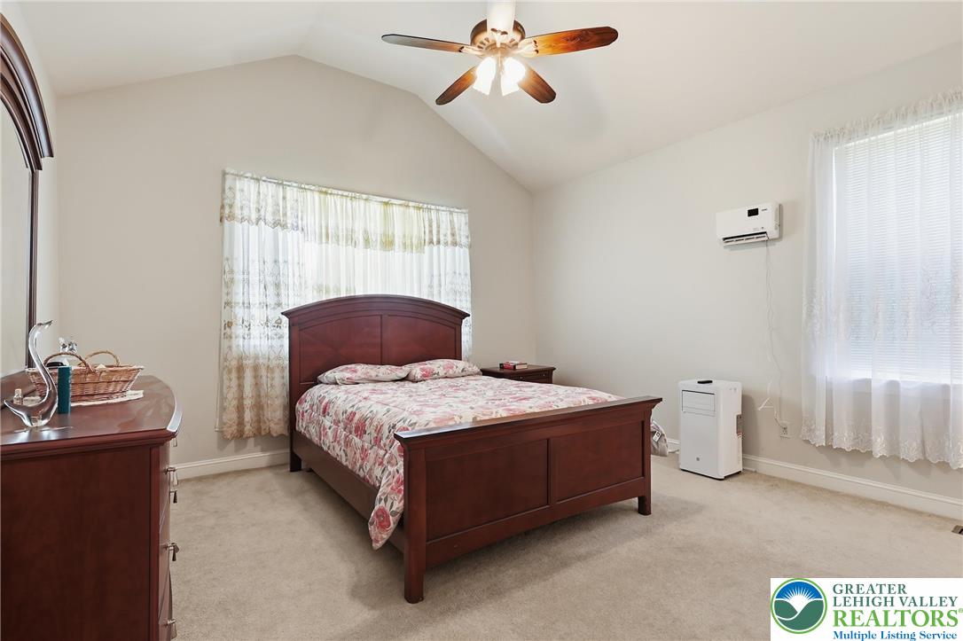 5217 Cider Press Road Schnecksville, PA 18078 - Photo 34 of 54 a bedroom with a bed and a chandelier