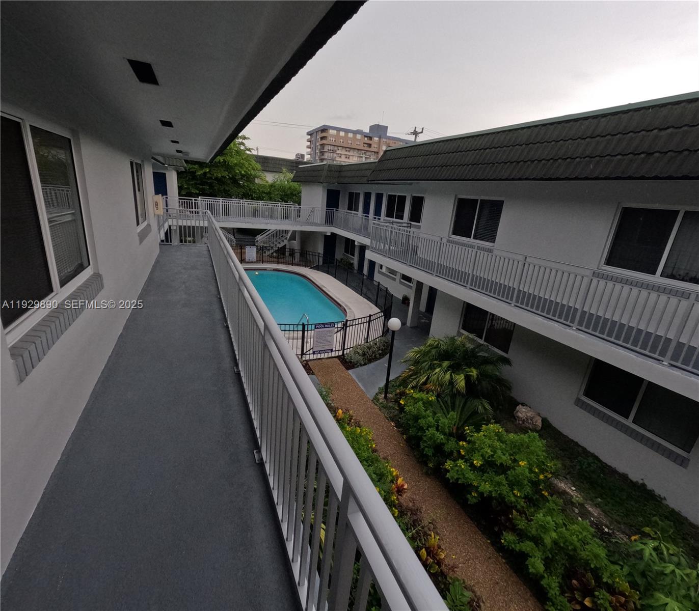 a balcony with wooden floor outdoor seating and stairs
