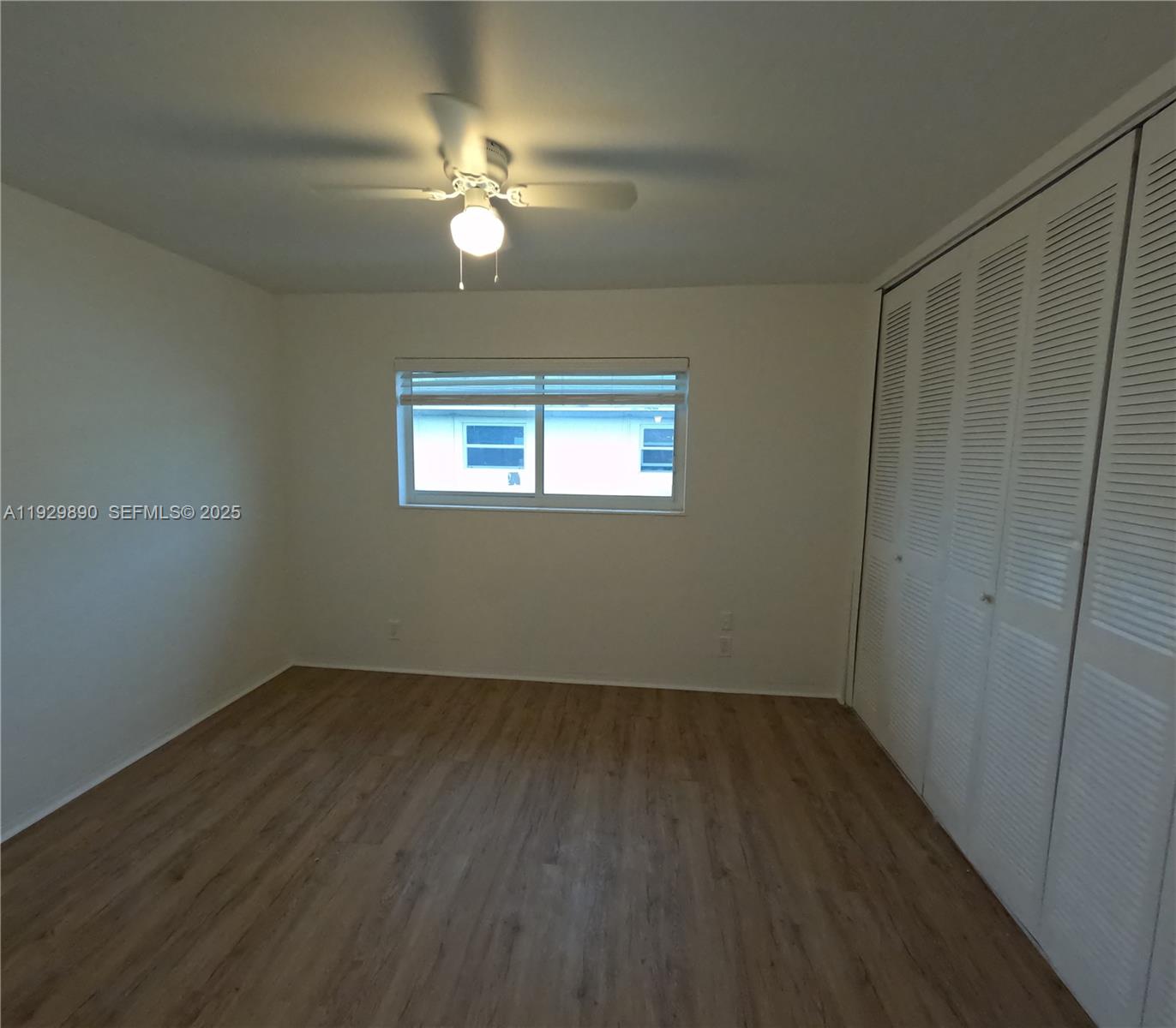 1010 Southeast 15th Street, Unit 209 Fort Lauderdale, FL 33316 - Photo 8 of 10 an empty room with wooden floor and windows