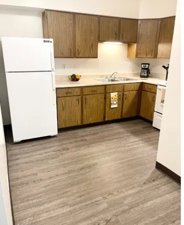 a kitchen with stainless steel appliances refrigerator sink and cabinets