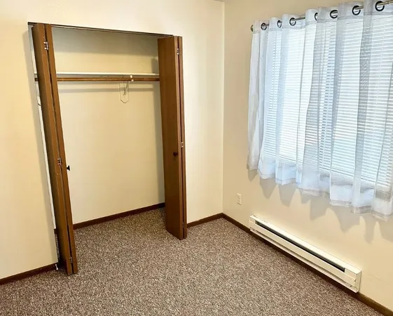 a bathroom with a tub and a large window