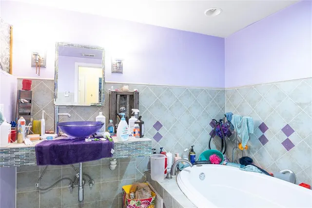 a bedroom with furniture and a flat tv screen