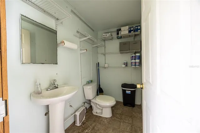 a yellow house with tall trees in the background