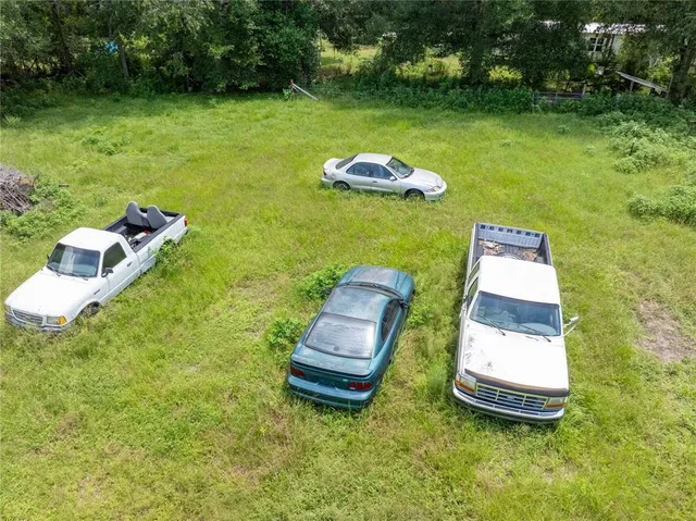 a view of a house with a garden and sitting area