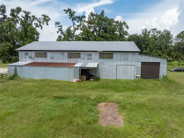 an aerial view of a house with swimming pool garden and patio