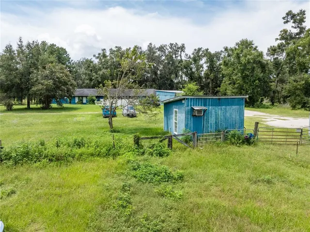 an aerial view of a house with outdoor space and a lake view