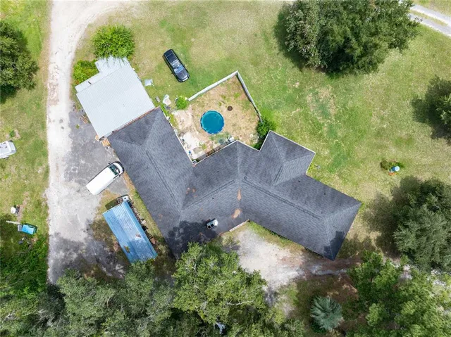 an aerial view of a house with outdoor space