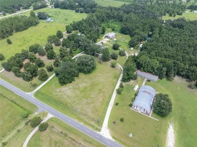 a view of a swimming pool with a yard and outdoor seating