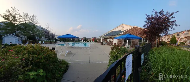 a view of house with swimming pool and furniture