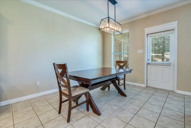 a view of a dining room with furniture and window