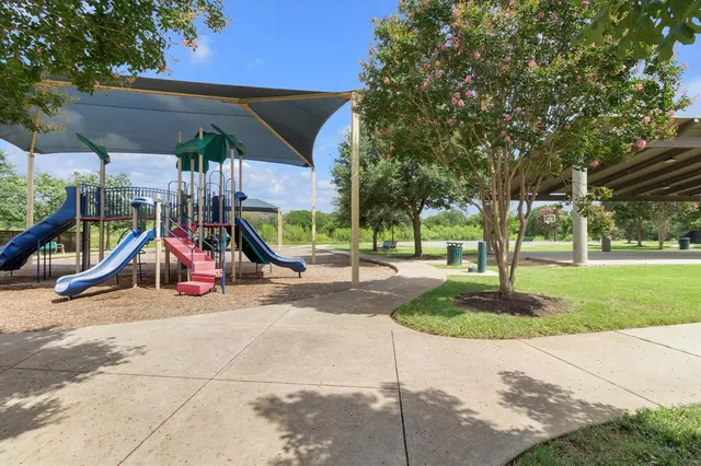 a view of outdoor space with playground and green space