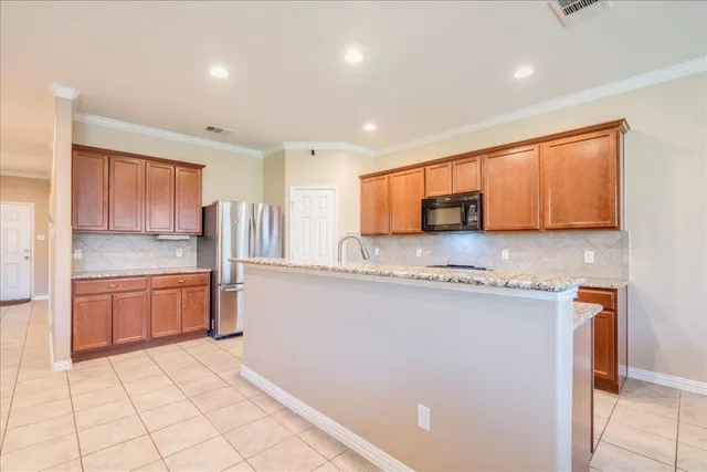 a kitchen with stainless steel appliances granite countertop a refrigerator sink and cabinets