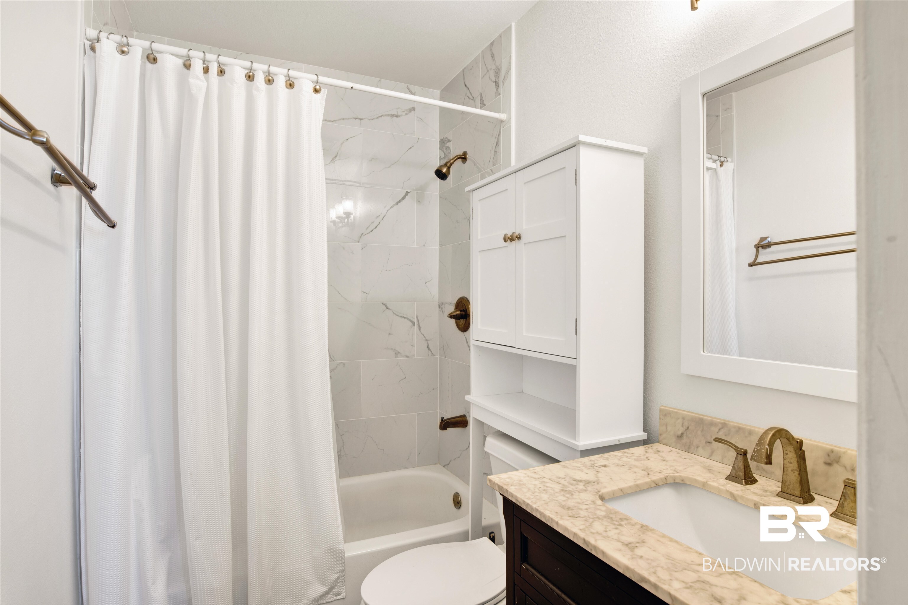26913 Marina Road, Unit 213 Orange Beach, AL 36561 - Photo 21 of 30 Full bathroom with vanity, toilet, and shower / tub combo with curtain