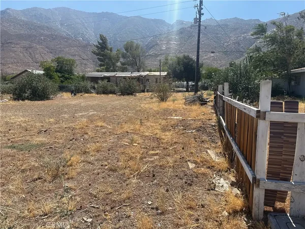 a view of a pathway with a wrought fence