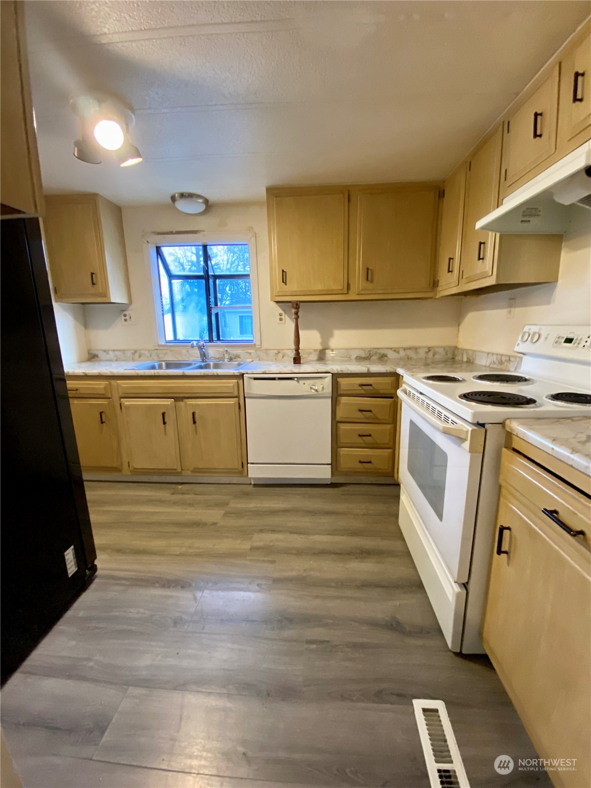 5600 Mt Solo Road, Unit 73 Longview, WA 98632 - Photo 5 of 18 a kitchen with a stove top oven sink and cabinets