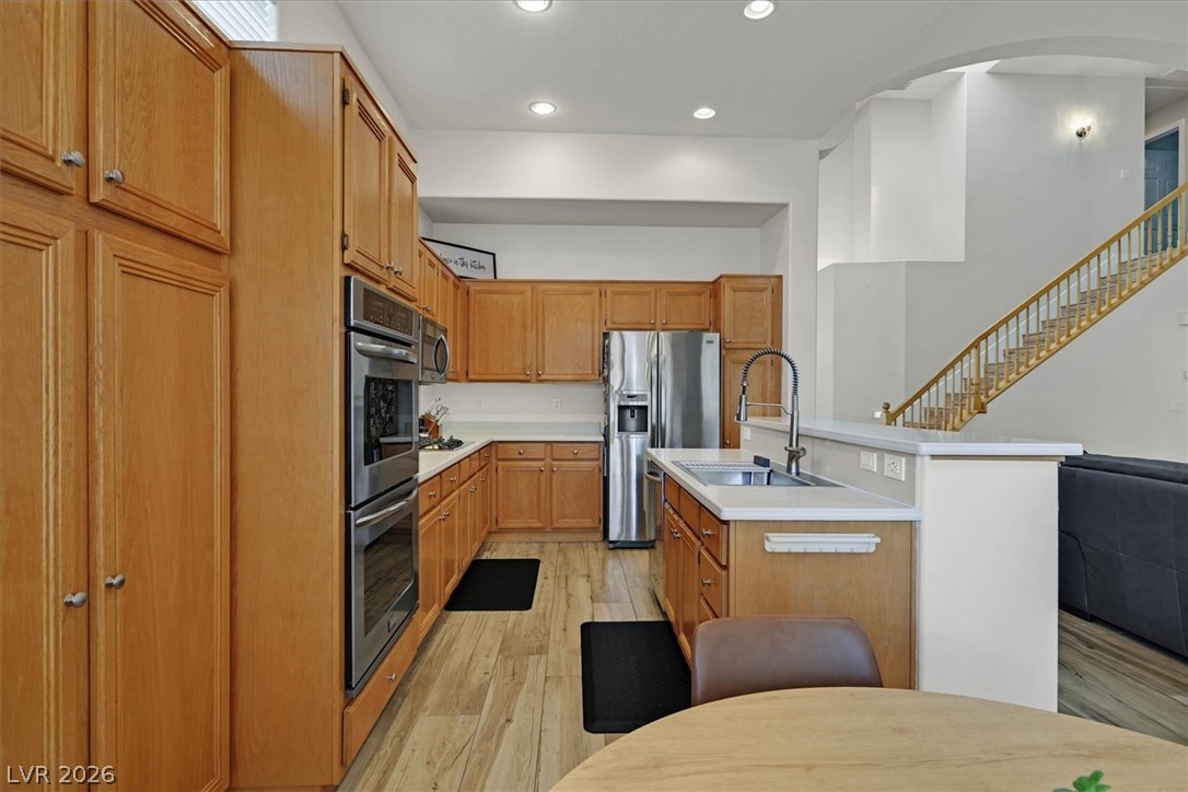 1259 Moon Vision Street Henderson, NV 89052 - Photo 12 of 53 A well-appointed kitchen features stainless steel appliances, abundant cabinetry, and a convenient kitchen island.
