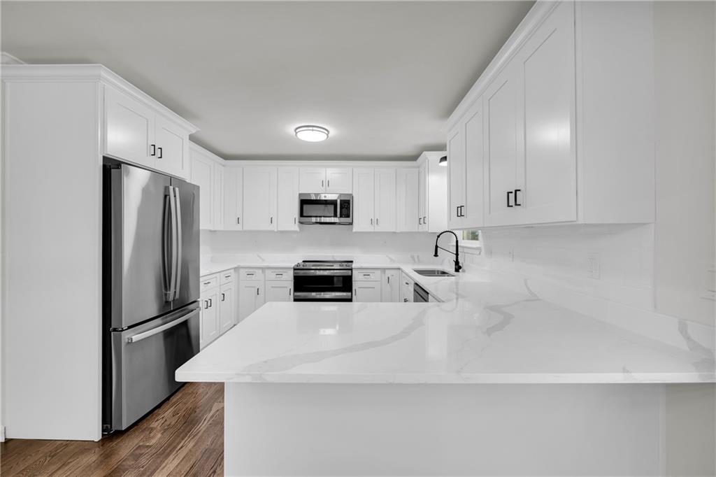 2941 Lake Hollow Road Gainesville, GA 30501 - Photo 18 of 53 a kitchen with stainless steel appliances a refrigerator sink and microwave