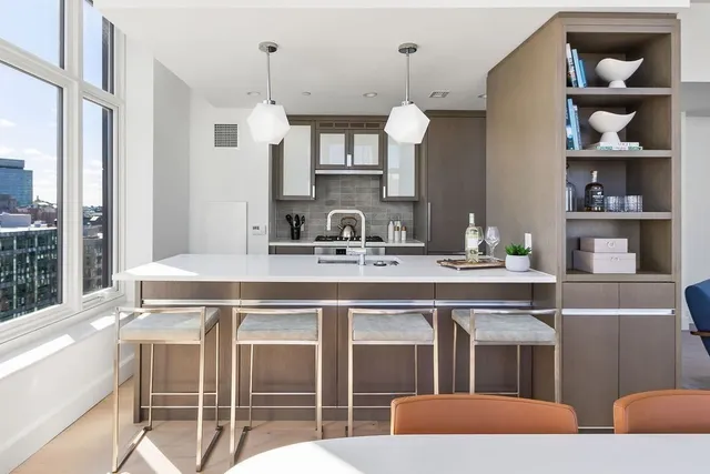 a kitchen with a sink cabinets and window