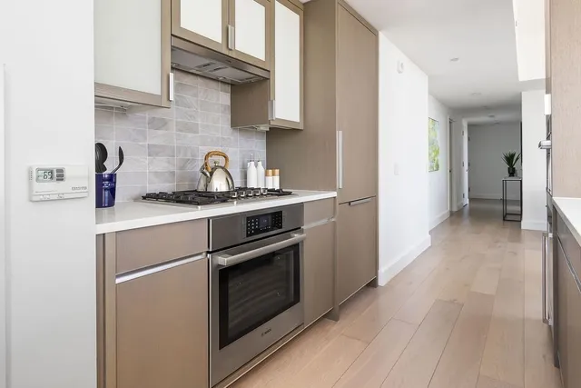 a kitchen with stainless steel appliances granite countertop a stove and a refrigerator