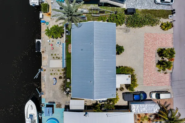 a view of a house with a yard from a lake view