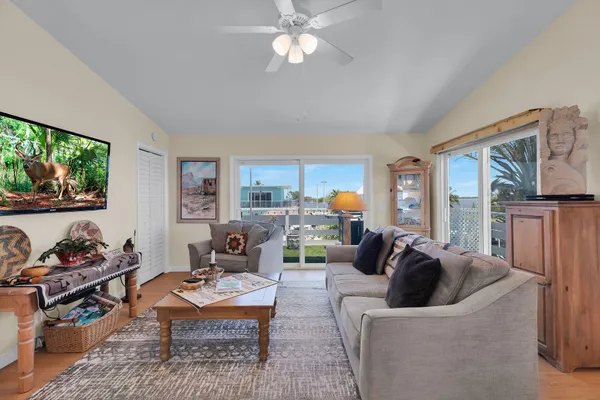 a living room with furniture and view of kitchen