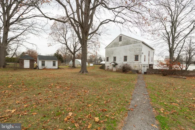 a front view of a house with a yard covered with snow