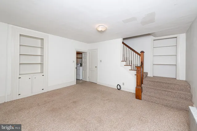 a view of an empty room with stairs and ventilation