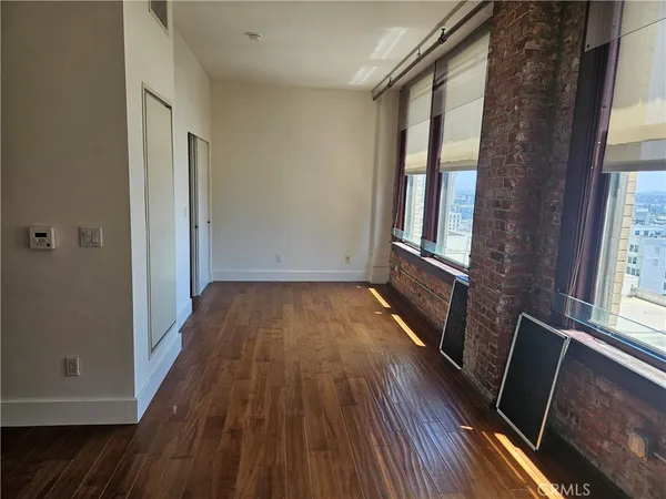 a view of a room with wooden floor and staircase