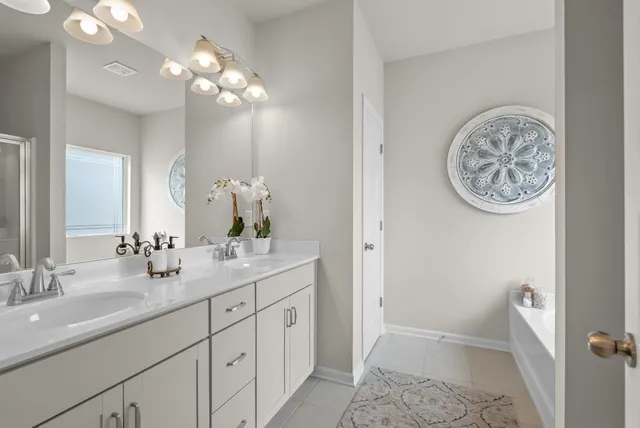 a bathroom with a double vanity sink and a mirror
