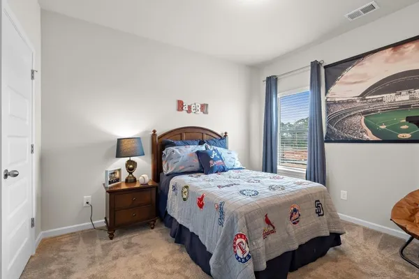 a bed sitting in a bedroom next to a window