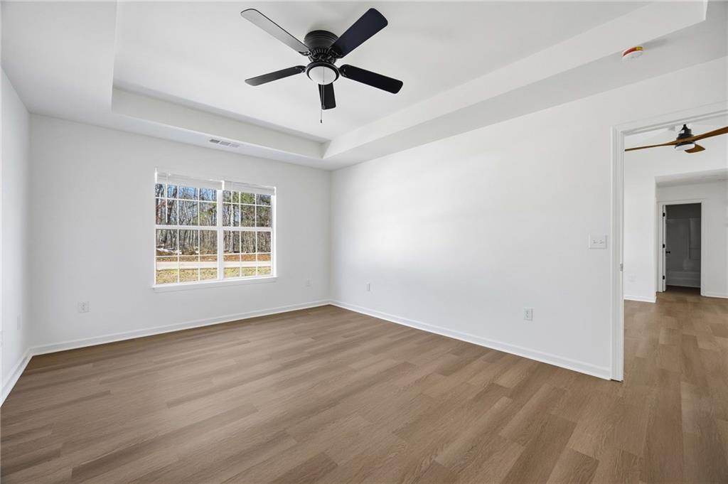 444 McGiboney Road Covington, GA 30016 - Photo 17 of 26 wooden floor in an empty room with a window
