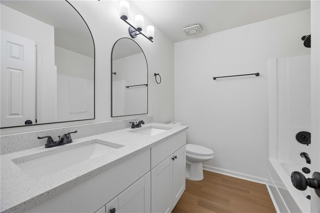 444 McGiboney Road Covington, GA 30016 - Photo 19 of 26 a bathroom with a sink and mirror with toilet