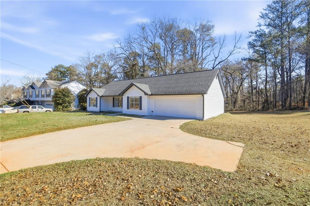 444 McGiboney Road Covington, GA 30016 - Photo 24 of 26 a house with trees in front of it