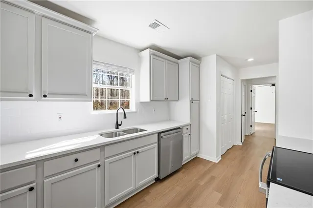 a kitchen with a sink cabinets and window