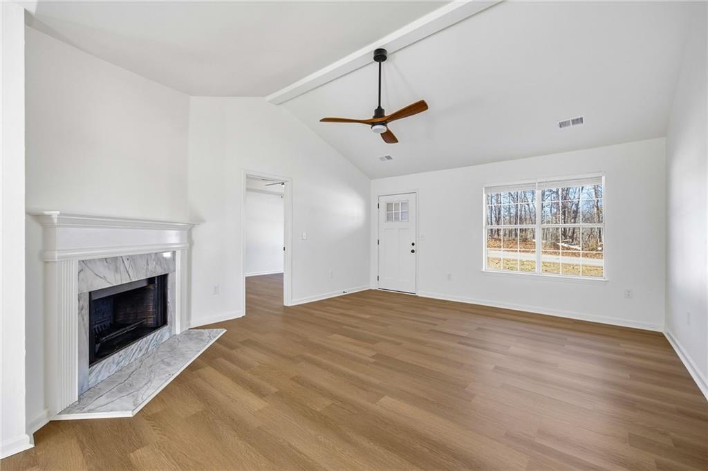 444 McGiboney Road Covington, GA 30016 - Photo 6 of 26 a view of empty room with fireplace and windows