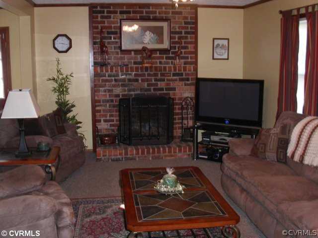 6020 Barrister Road Chesterfield, VA 23832 - Photo 8 of 12 a living room with furniture a flat screen tv and a fireplace